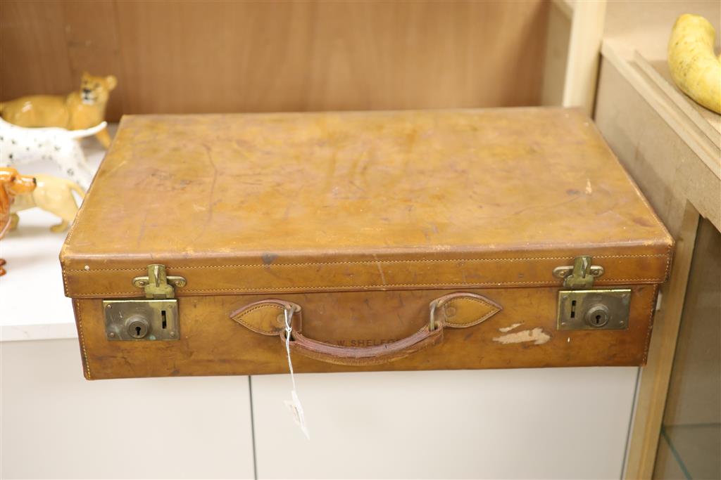 A gentlemans Edwardian leather cased travelling toilet set, including silver mounted glass toilet bottles